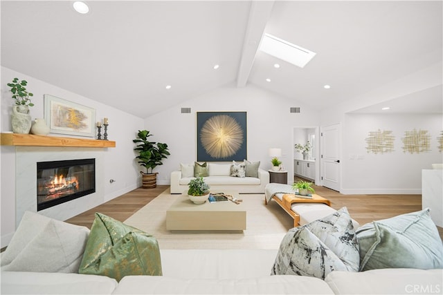12 Creekside, Irvine, CA 92603 - living area featuring a skylight, wood finished floors, a glass covered fireplace, and recessed lighting