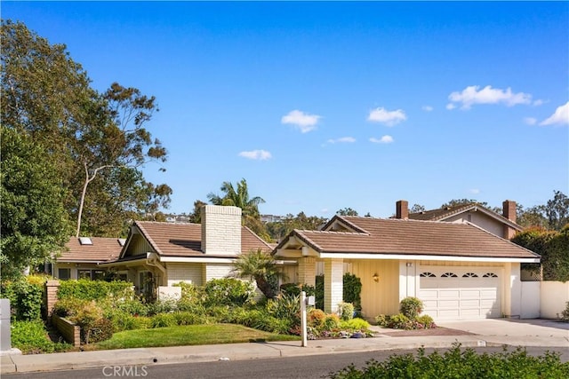 12 Creekside, Irvine, CA 92603 - single story home featuring a chimney, an attached garage, a tiled roof, and concrete driveway