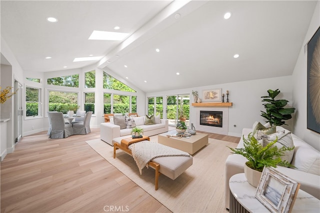 12 Creekside, Irvine, CA 92603 - living area featuring beam ceiling, light wood-style floors, a glass covered fireplace, recessed lighting, and a skylight