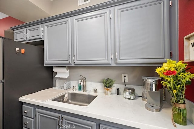375 Central Ave Unit 196, Riverside, CA 92507 - kitchen featuring gray cabinetry, freestanding refrigerator, and light countertops