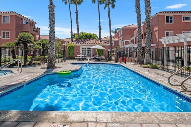 409 Utica Ave Unit C23, Huntington Beach, CA 92648 - community pool featuring a patio, a residential view, a pergola, and french doors