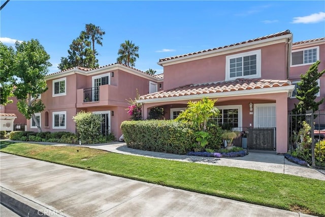 409 Utica Ave Unit C23, Huntington Beach, CA 92648 - mediterranean / spanish home with a tiled roof, stucco siding, and a gate