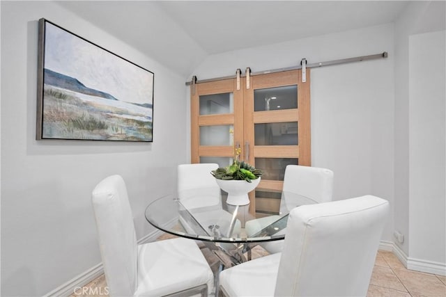 409 Utica Ave Unit C23, Huntington Beach, CA 92648 - dining area with a barn door, lofted ceiling, and light tile patterned flooring