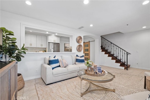 409 Utica Ave Unit C23, Huntington Beach, CA 92648 - living area featuring light tile patterned floors, recessed lighting, stairway, and arched walkways