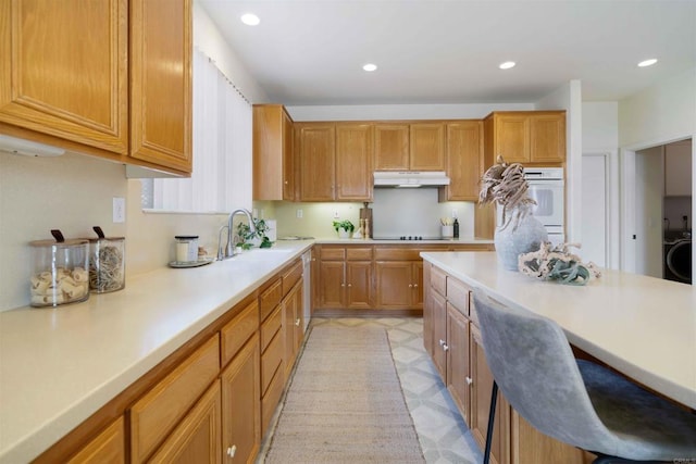 837 Calle Lagasca, Chula Vista, CA 91910 - kitchen featuring under cabinet range hood, double oven, light countertops, recessed lighting, and brown cabinetry