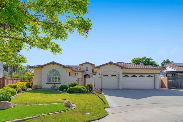 837 Calle Lagasca, Chula Vista, CA 91910 - mediterranean / spanish-style home featuring stucco siding, driveway, a garage, a tile roof, and a gate