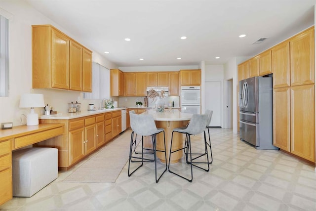 837 Calle Lagasca, Chula Vista, CA 91910 - kitchen featuring stainless steel fridge with ice dispenser, light floors, a kitchen breakfast bar, light countertops, and a kitchen island