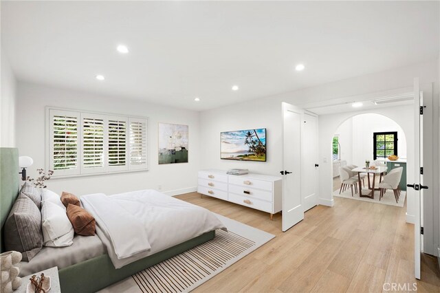 294 Calle Cuervo, San Clemente, CA 92672 - bedroom featuring arched walkways, recessed lighting, and light wood finished floors