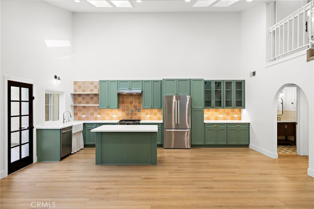 294 Calle Cuervo, San Clemente, CA 92672 - kitchen featuring green cabinets, stainless steel appliances, a high ceiling, light countertops, and arched walkways