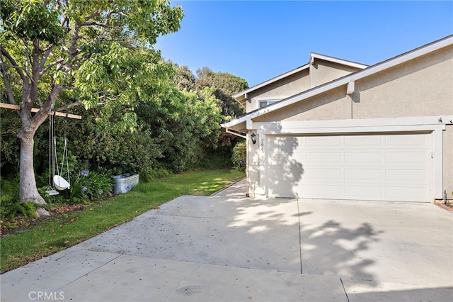 294 Calle Cuervo, San Clemente, CA 92672 - view of home's exterior featuring concrete driveway, stucco siding, and an attached garage