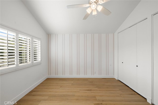 294 Calle Cuervo, San Clemente, CA 92672 - unfurnished bedroom with lofted ceiling, light wood-style flooring, wallpapered walls, a closet, and ceiling fan