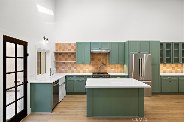 294 Calle Cuervo, San Clemente, CA 92672 - kitchen featuring stainless steel appliances, green cabinets, backsplash, open shelves, and light countertops