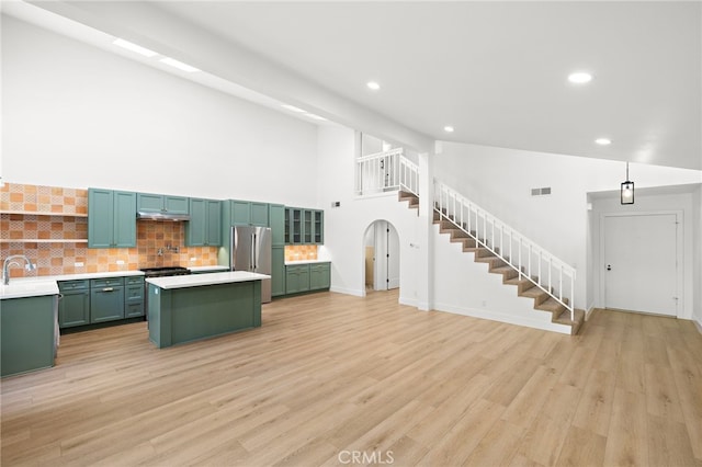 294 Calle Cuervo, San Clemente, CA 92672 - unfurnished living room with stairs, recessed lighting, light wood-style floors, and a high ceiling