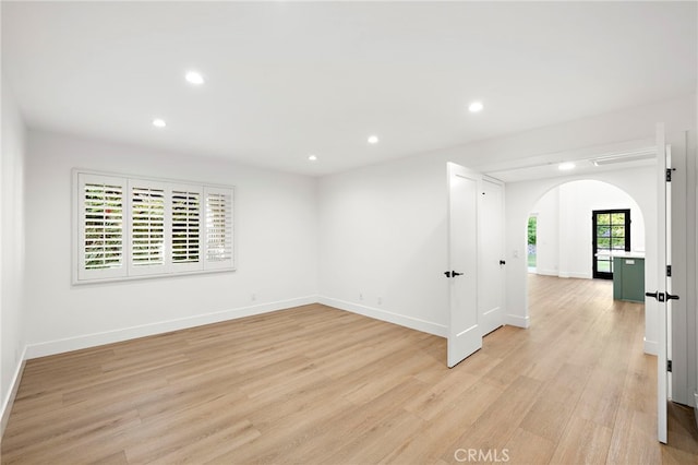 294 Calle Cuervo, San Clemente, CA 92672 - unfurnished room with arched walkways, light wood-type flooring, and recessed lighting