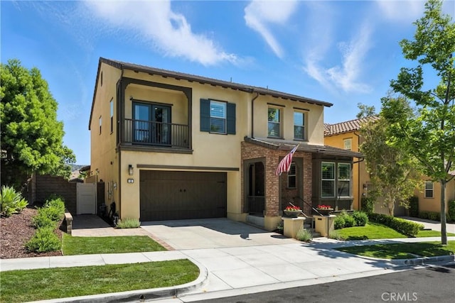 12 Rastro St, Rancho Mission Viejo, CA 92694 - view of front facade with stucco siding, an attached garage, concrete driveway, and a balcony