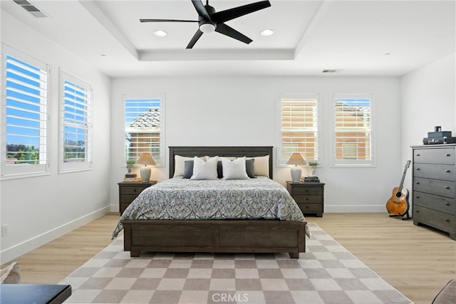 12 Rastro St, Rancho Mission Viejo, CA 92694 - bedroom with light wood-style floors, a tray ceiling, multiple windows, and recessed lighting