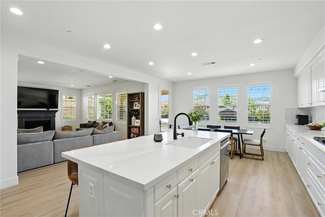 12 Rastro St, Rancho Mission Viejo, CA 92694 - kitchen with dishwasher, recessed lighting, light wood finished floors, white cabinets, and a center island with sink