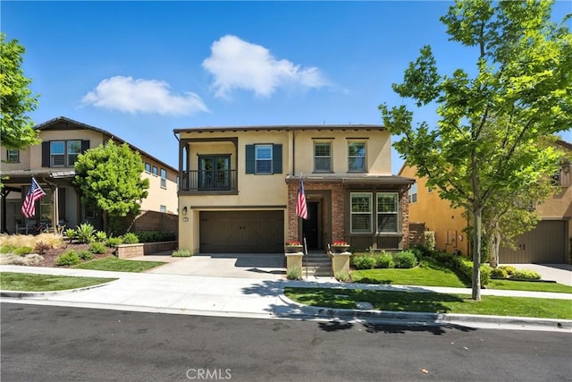 12 Rastro St, Rancho Mission Viejo, CA 92694 - view of front facade featuring stucco siding, a garage, driveway, and a balcony