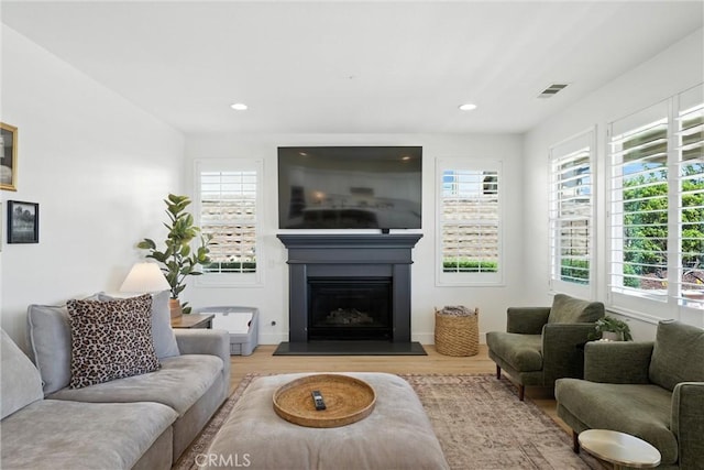 12 Rastro St, Rancho Mission Viejo, CA 92694 - living room with wood finished floors, a glass covered fireplace, and recessed lighting