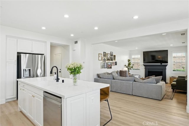 12 Rastro St, Rancho Mission Viejo, CA 92694 - kitchen with stainless steel appliances, white cabinets, healthy amount of natural light, and recessed lighting