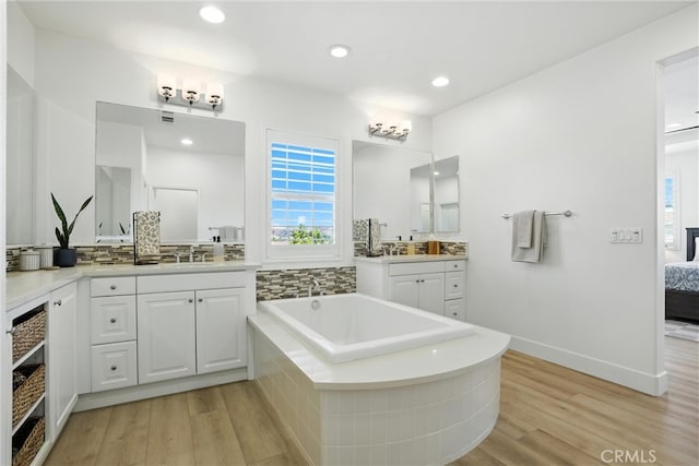 12 Rastro St, Rancho Mission Viejo, CA 92694 - bathroom featuring wood finished floors, ensuite bath, a garden tub, vanity, and recessed lighting