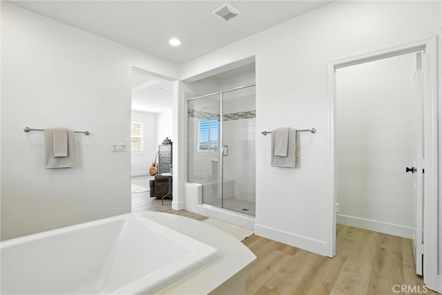 12 Rastro St, Rancho Mission Viejo, CA 92694 - bathroom featuring a shower stall, a garden tub, wood finished floors, and recessed lighting