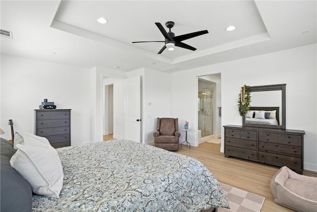 12 Rastro St, Rancho Mission Viejo, CA 92694 - bedroom featuring a tray ceiling, light wood-type flooring, recessed lighting, ceiling fan, and connected bathroom