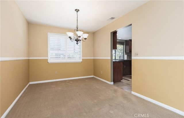 36151 Sharon Way, Yucaipa, CA 92399 - empty room featuring a chandelier and light colored carpet