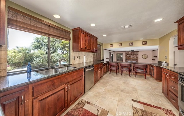 36151 Sharon Way, Yucaipa, CA 92399 - kitchen with appliances with stainless steel finishes, recessed lighting, light tile patterned floors, tasteful backsplash, and dark stone counters