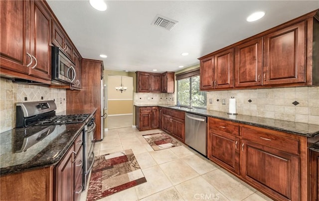 36151 Sharon Way, Yucaipa, CA 92399 - kitchen featuring appliances with stainless steel finishes, decorative backsplash, recessed lighting, light tile patterned floors, and dark stone counters