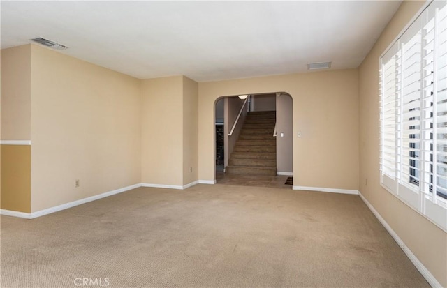 36151 Sharon Way, Yucaipa, CA 92399 - carpeted empty room with arched walkways, healthy amount of natural light, and stairs