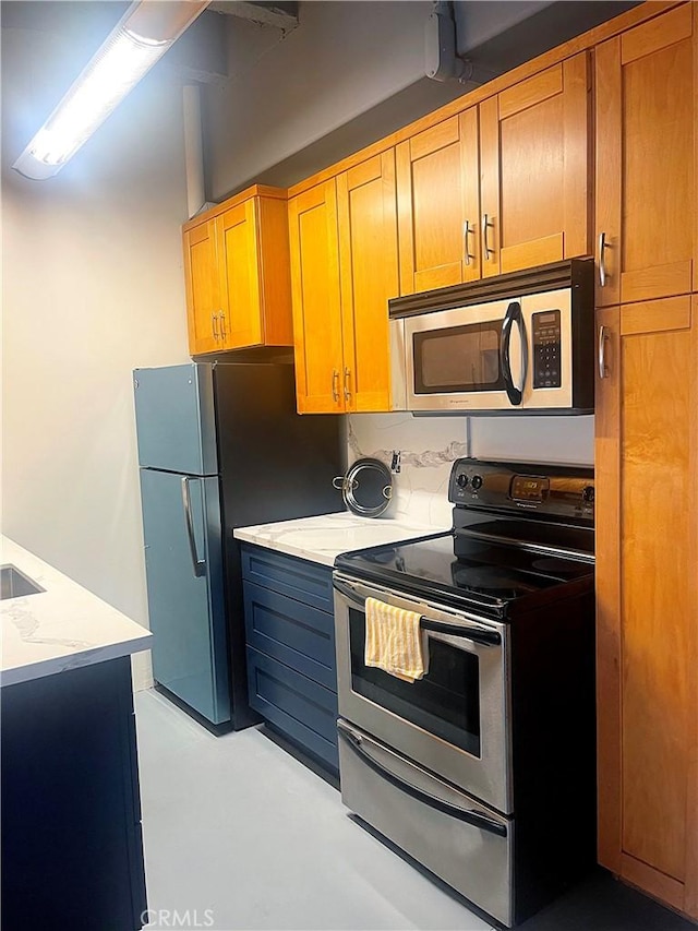 312 W 5th St Unit 1003, Los Angeles, CA 90013 - kitchen with stainless steel appliances and concrete floors