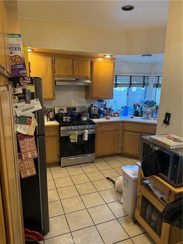 2714 S Montego # E, Ontario, CA 91761 - kitchen with stainless steel appliances, under cabinet range hood, light countertops, and light tile patterned flooring