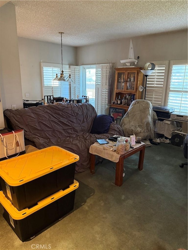 2714 S Montego # E, Ontario, CA 91761 - living room with a textured ceiling, carpet flooring, and a chandelier