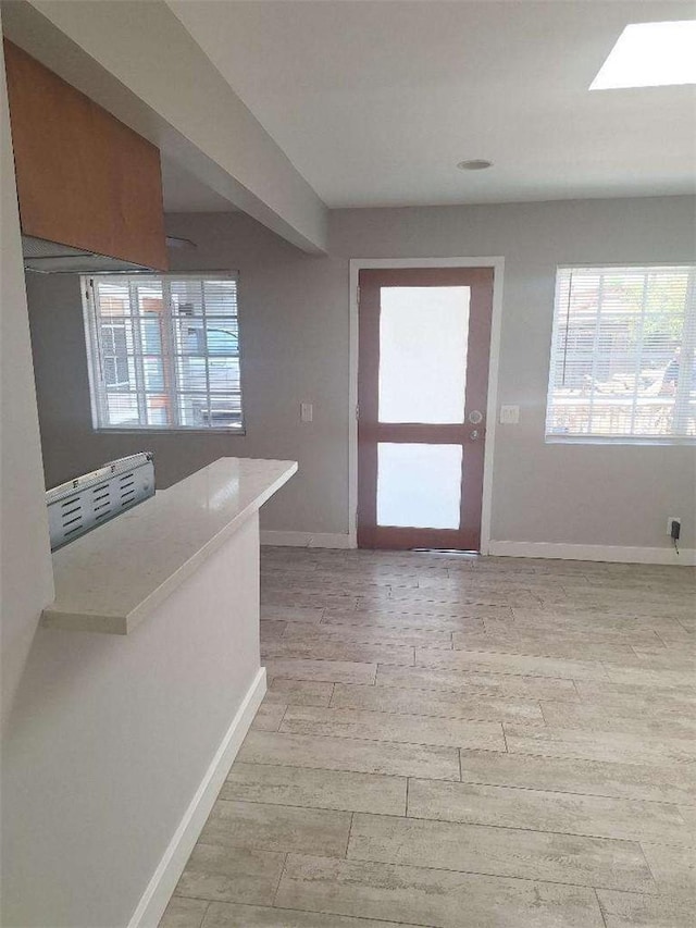 2109 N Marengo Ave, Altadena, CA 91001 - kitchen featuring healthy amount of natural light, light wood-style flooring, light countertops, and a skylight