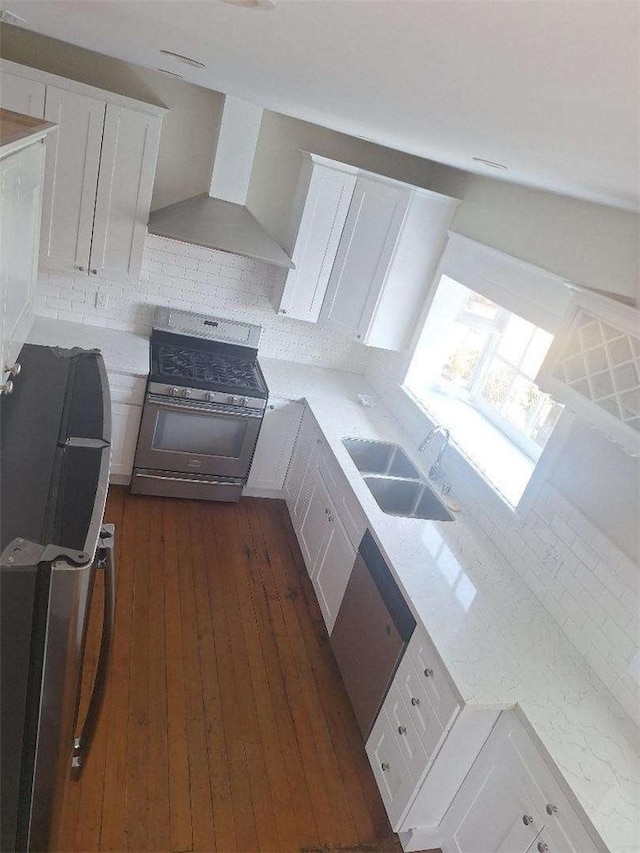 2109 N Marengo Ave, Altadena, CA 91001 - kitchen with stainless steel range with gas stovetop, wall chimney range hood, white cabinets, dark wood finished floors, and backsplash