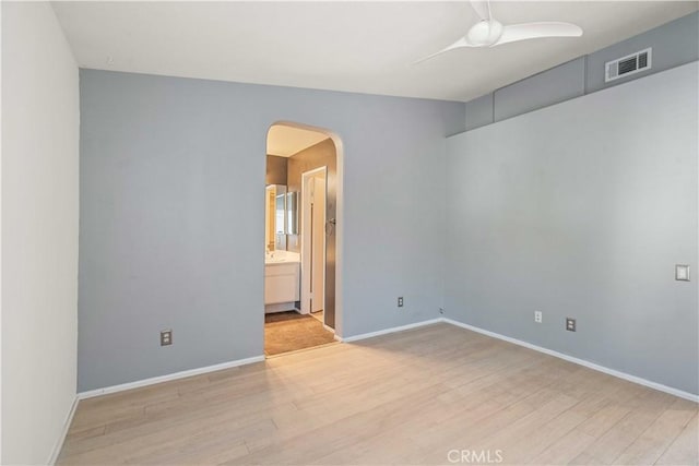 23612 Muir Trl Unit 74, Valencia, CA 91354 - empty room featuring light wood-style flooring, arched walkways, and ceiling fan