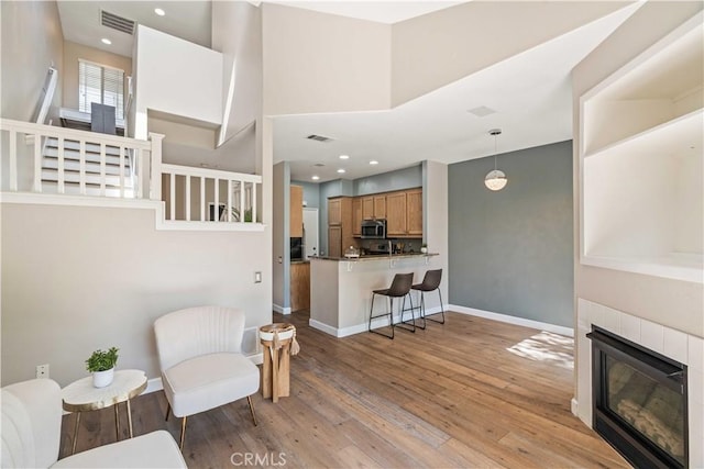 23612 Muir Trl Unit 74, Valencia, CA 91354 - living area featuring wood finished floors, a tile fireplace, and recessed lighting