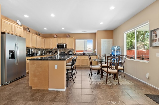 29063 Boulder Crest Way, Menifee, CA 92584 - kitchen with stainless steel appliances, backsplash, recessed lighting, a center island with sink, and light brown cabinets