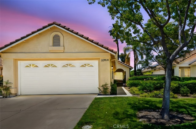 23974 Via Astuto, Murrieta, CA 92562 - mediterranean / spanish-style home featuring concrete driveway, stucco siding, a tile roof, and a garage