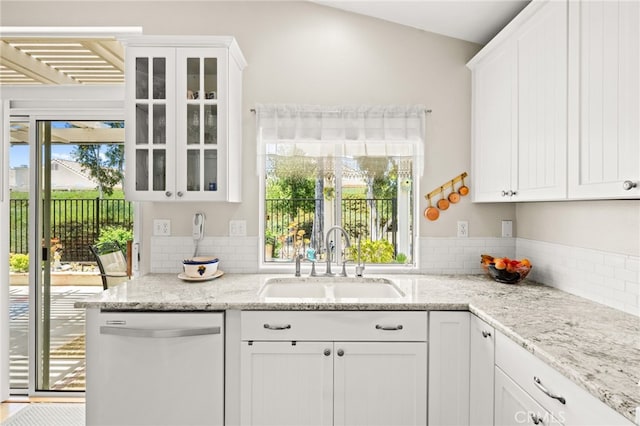 23974 Via Astuto, Murrieta, CA 92562 - kitchen with white dishwasher, glass insert cabinets, white cabinetry, and backsplash