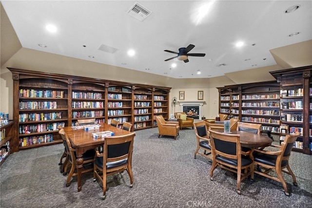 23974 Via Astuto, Murrieta, CA 92562 - carpeted dining room with a ceiling fan, a lit fireplace, and recessed lighting
