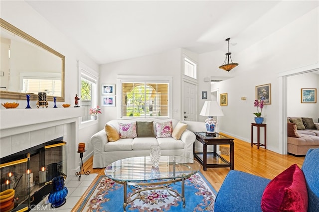 23974 Via Astuto, Murrieta, CA 92562 - living room featuring lofted ceiling, wood finished floors, and a tile fireplace
