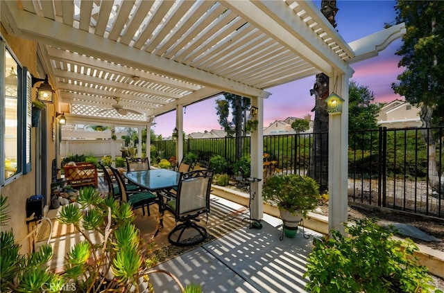 23974 Via Astuto, Murrieta, CA 92562 - patio terrace at dusk featuring a pergola, outdoor dining area, a fenced backyard, and a patio