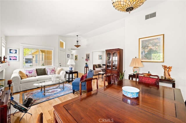 23974 Via Astuto, Murrieta, CA 92562 - living room featuring wood finished floors and lofted ceiling