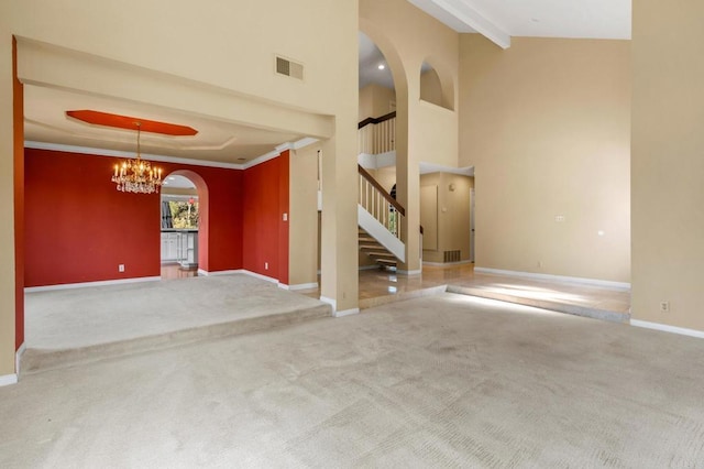 4750 Jeffer Ln, La Mesa, CA 91941 - unfurnished living room with carpet floors, a chandelier, arched walkways, stairway, and a towering ceiling