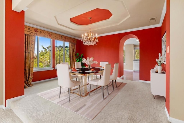 4750 Jeffer Ln, La Mesa, CA 91941 - dining space featuring arched walkways, a chandelier, carpet, a raised ceiling, and crown molding