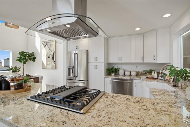 16743 Bayview Dr Unit A, Sunset Beach, CA 90742 - kitchen with stainless steel appliances, island range hood, light stone counters, white cabinets, and recessed lighting