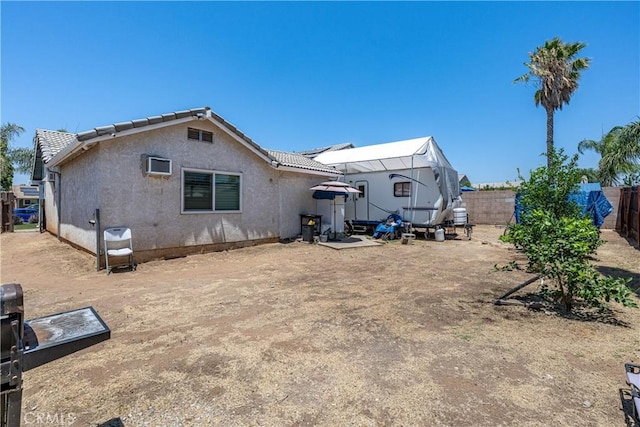 13848 Golden Eagle Ct, Moreno Valley, CA 92553 - rear view of house with a fenced backyard, stucco siding, and a tiled roof