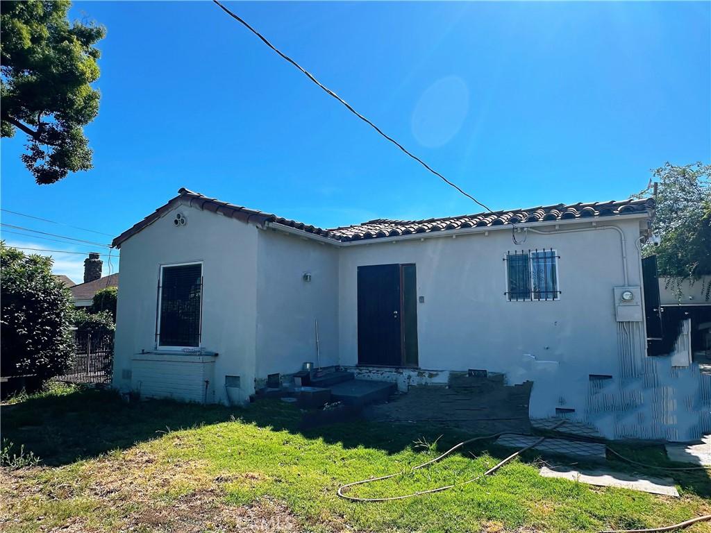 1803 S Charlotte Ave, San Gabriel, CA 91776 - rear view of house featuring a tiled roof, a lawn, and stucco siding